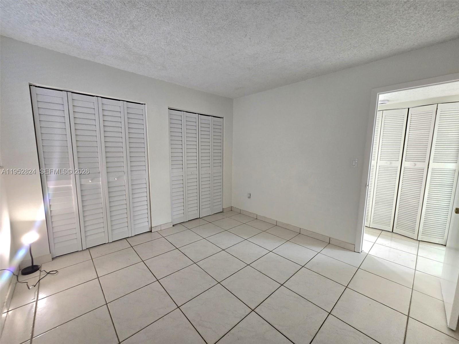 10090 Northwest 80th Court, Unit 1155 Hialeah Gardens, FL 33016 - Photo 11 of 19 a view of an empty room and window