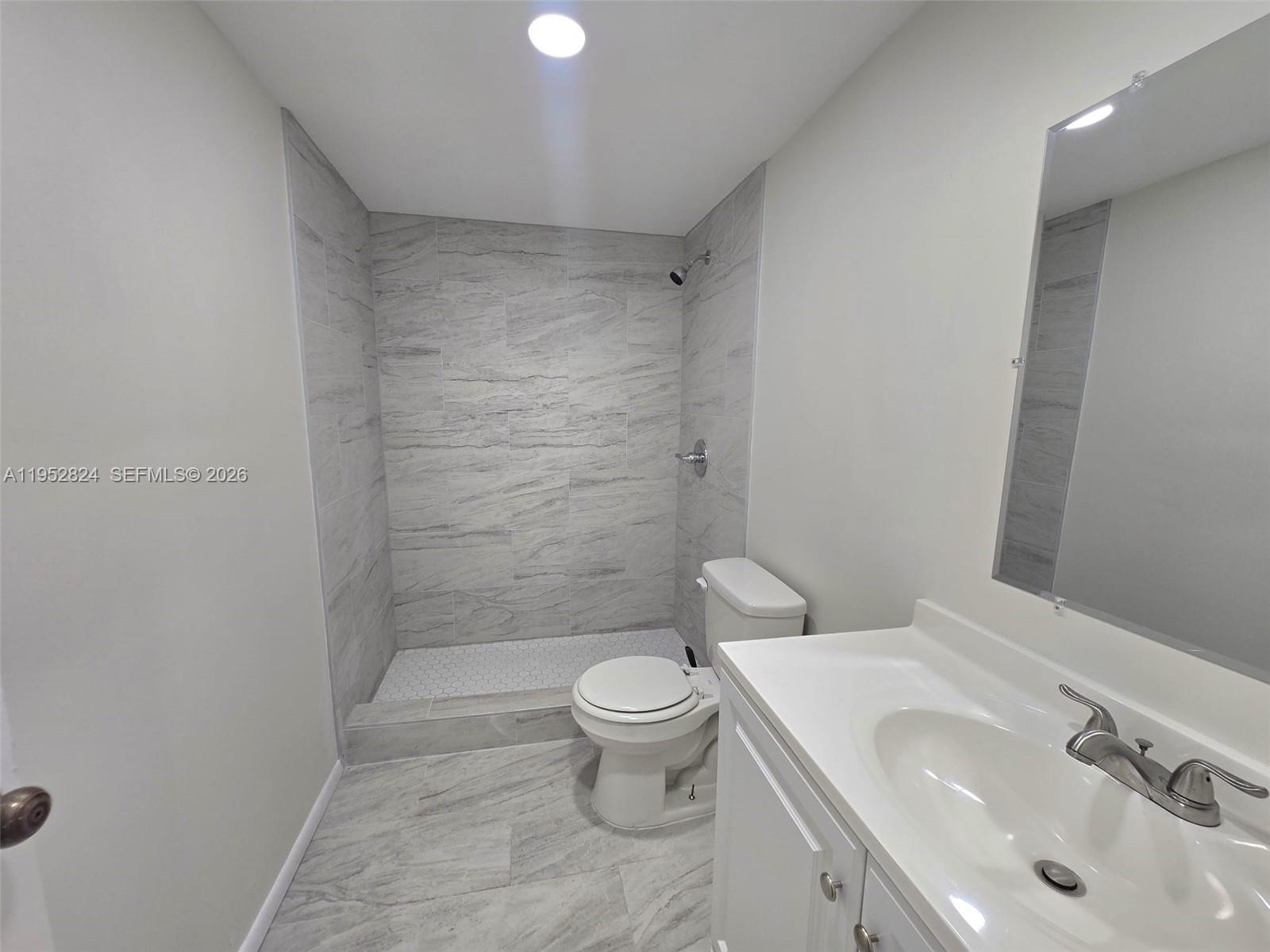 10090 Northwest 80th Court, Unit 1155 Hialeah Gardens, FL 33016 - Photo 12 of 19 a bathroom with a sink a toilet and shower