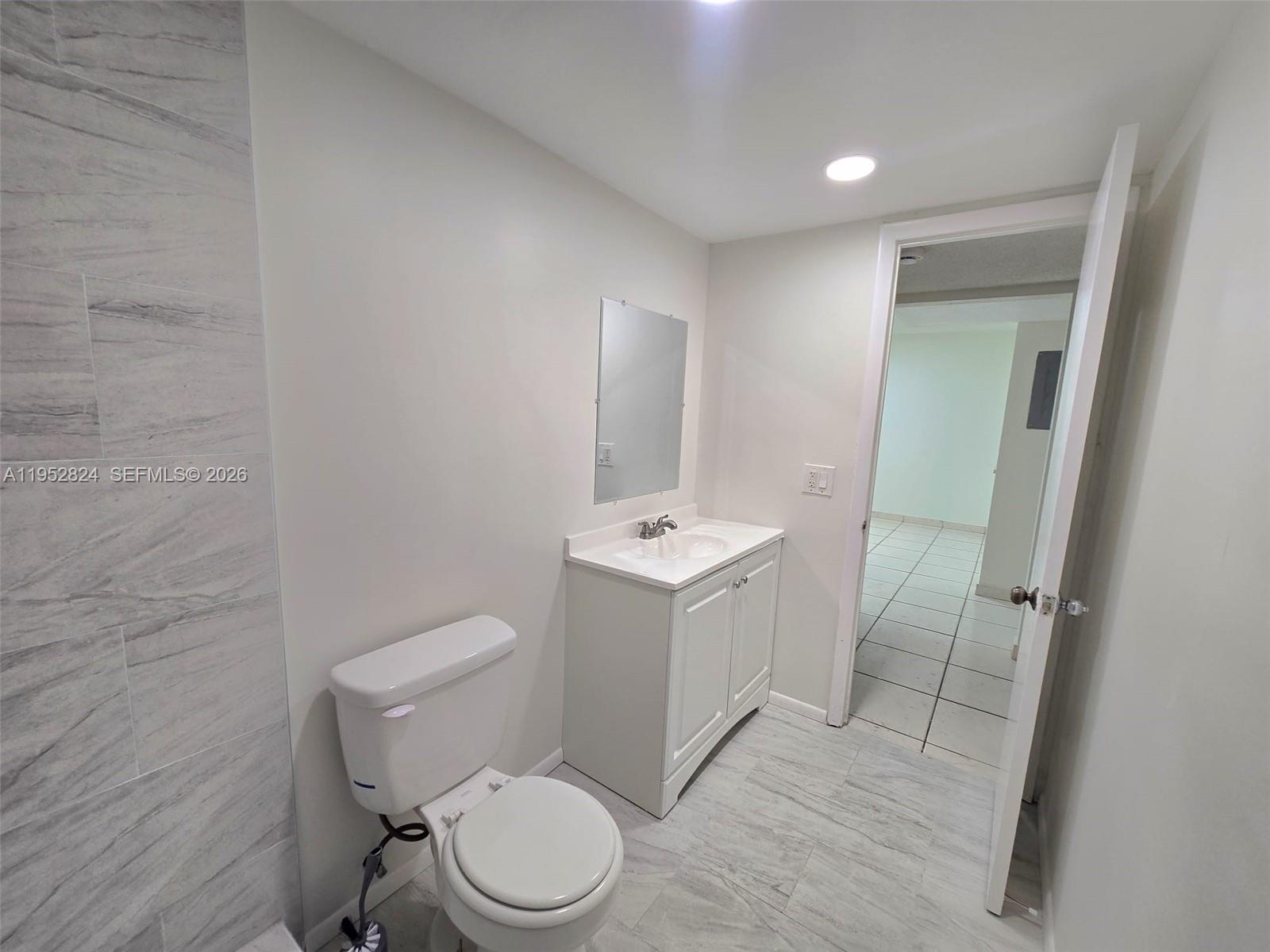 10090 Northwest 80th Court, Unit 1155 Hialeah Gardens, FL 33016 - Photo 14 of 19 a white toilet sitting next to a bathroom sink