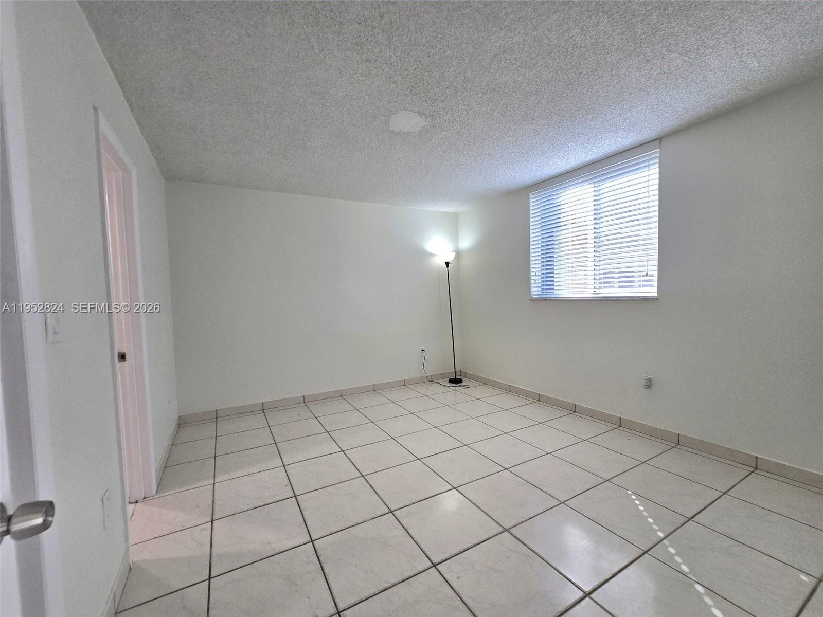 10090 Northwest 80th Court, Unit 1155 Hialeah Gardens, FL 33016 - Photo 15 of 19 a view of an empty room and window