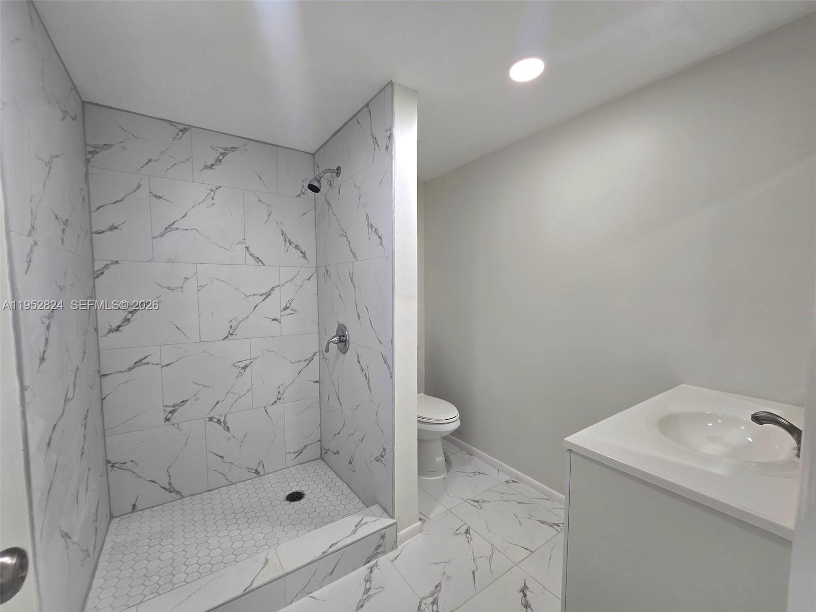 10090 Northwest 80th Court, Unit 1155 Hialeah Gardens, FL 33016 - Photo 19 of 19 a bathroom with a sink toilet and shower