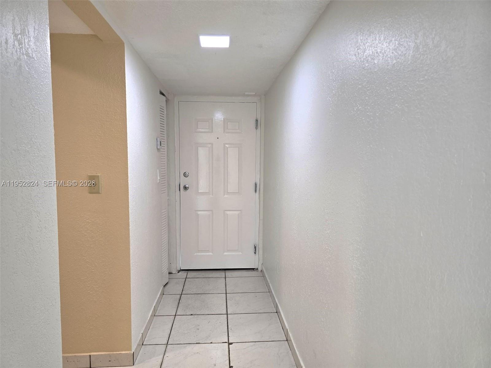 10090 Northwest 80th Court, Unit 1155 Hialeah Gardens, FL 33016 - Photo 2 of 19 a view of an empty room