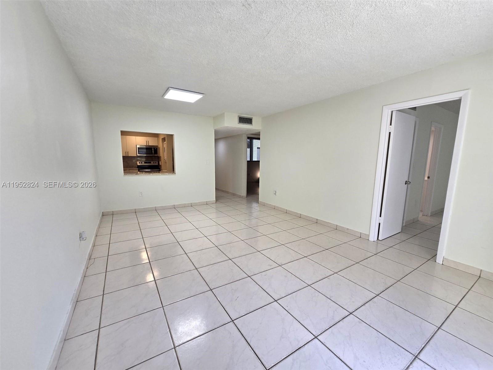 10090 Northwest 80th Court, Unit 1155 Hialeah Gardens, FL 33016 - Photo 7 of 19 a view of an empty room and window