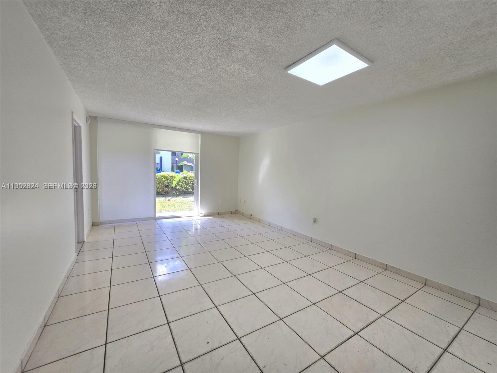 10090 Northwest 80th Court, Unit 1155 Hialeah Gardens, FL 33016 - Photo 8 of 19 a view of an empty room and window