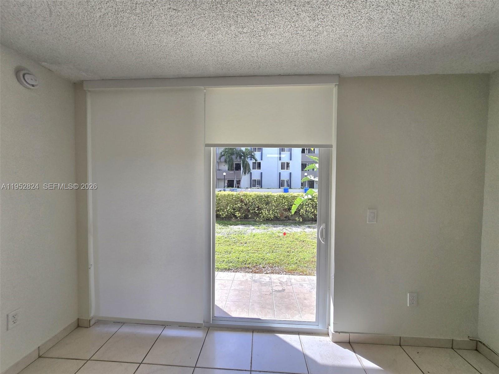 10090 Northwest 80th Court, Unit 1155 Hialeah Gardens, FL 33016 - Photo 9 of 19 a view of an empty room and window