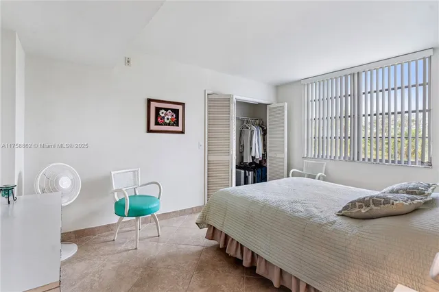 a bed room with a bed and a chair