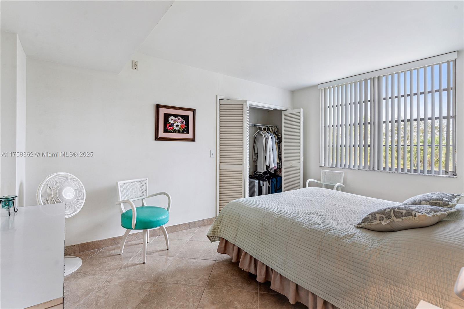 3800 Oaks Clubhouse Drive, Unit 307 Pompano Beach, FL 33069 - Photo 13 of 25 a bedroom with a bed and a window