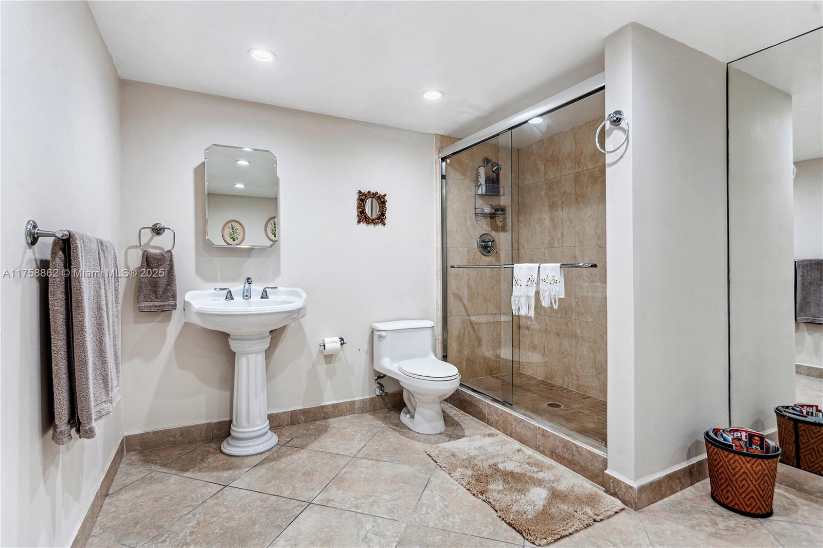 3800 Oaks Clubhouse Drive, Unit 307 Pompano Beach, FL 33069 - Photo 16 of 25 a bathroom with a sink toilet and shower