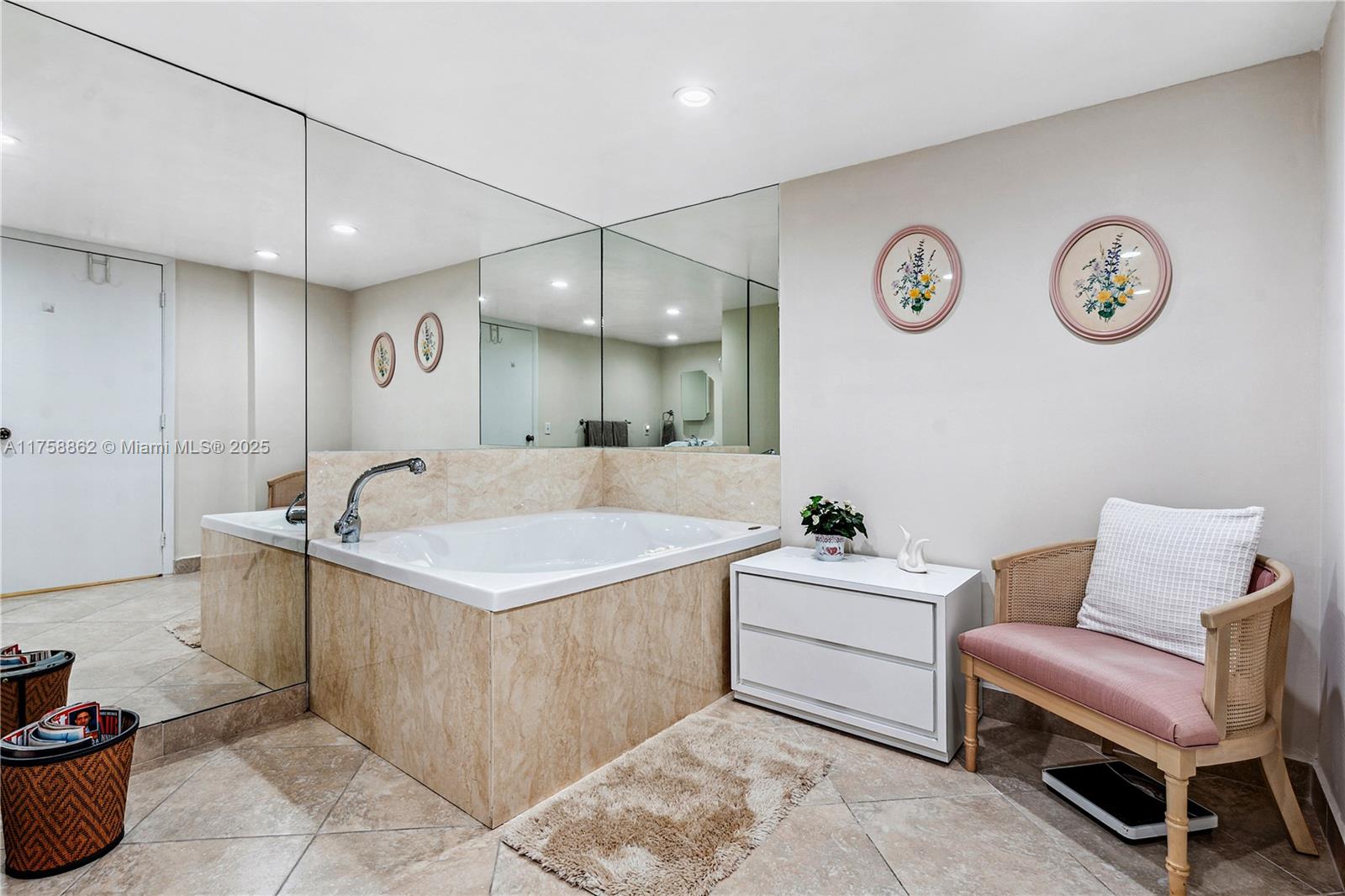 3800 Oaks Clubhouse Drive, Unit 307 Pompano Beach, FL 33069 - Photo 17 of 25 a bathroom with a sink a vanity and a mirror