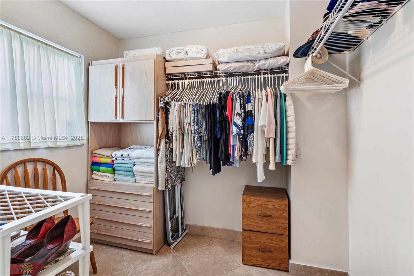3800 Oaks Clubhouse Drive, Unit 307 Pompano Beach, FL 33069 - Photo 18 of 25 a view of walk in closet with clothes and shoes