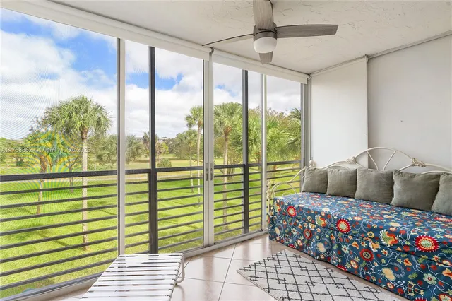 a living room with furniture and a floor to ceiling window