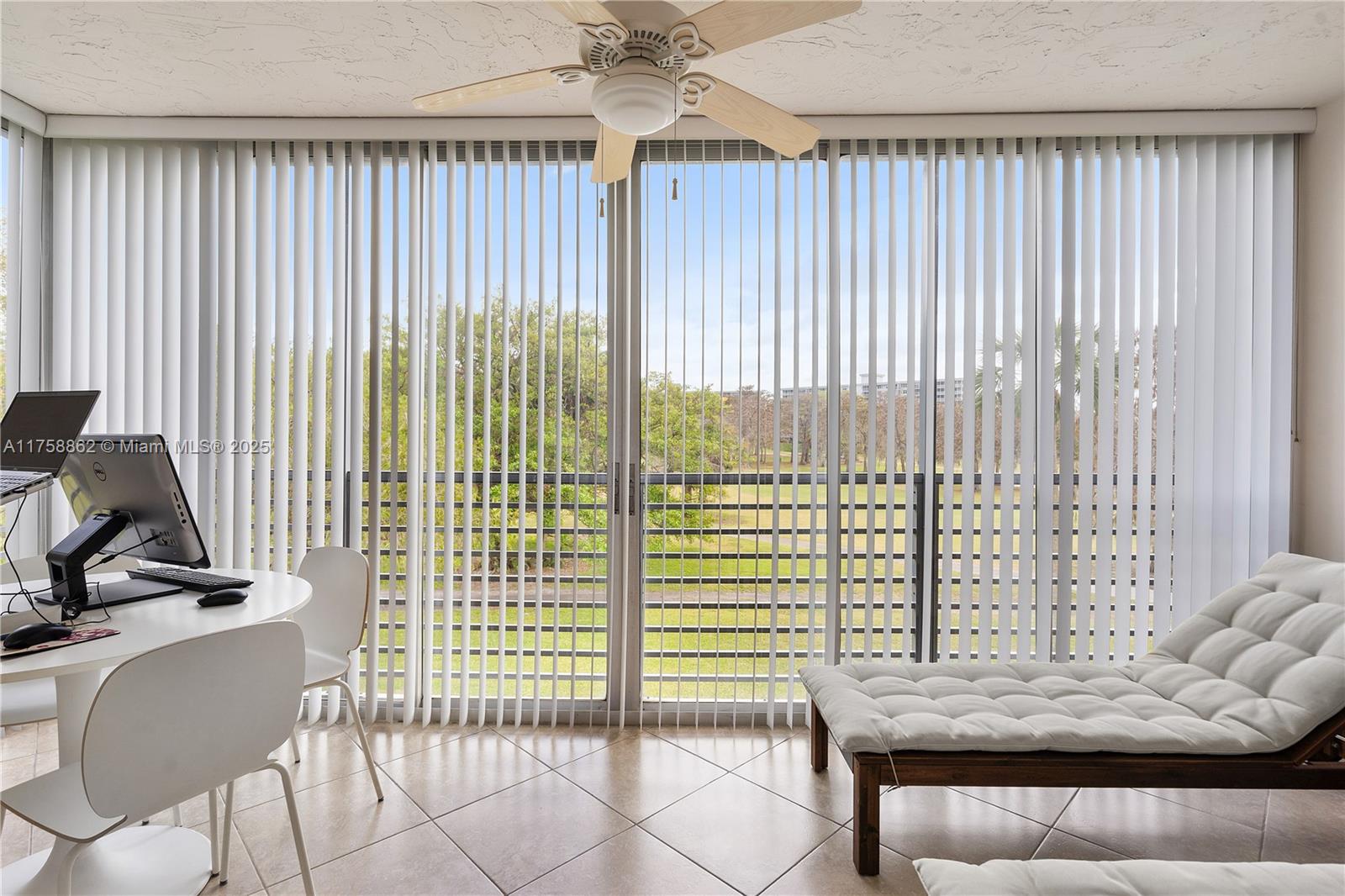 3800 Oaks Clubhouse Drive, Unit 307 Pompano Beach, FL 33069 - Photo 20 of 25 a living room with furniture and a floor to ceiling window
