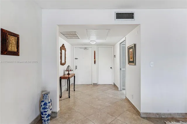 a kitchen with stainless steel appliances granite countertop a refrigerator sink and white cabinets