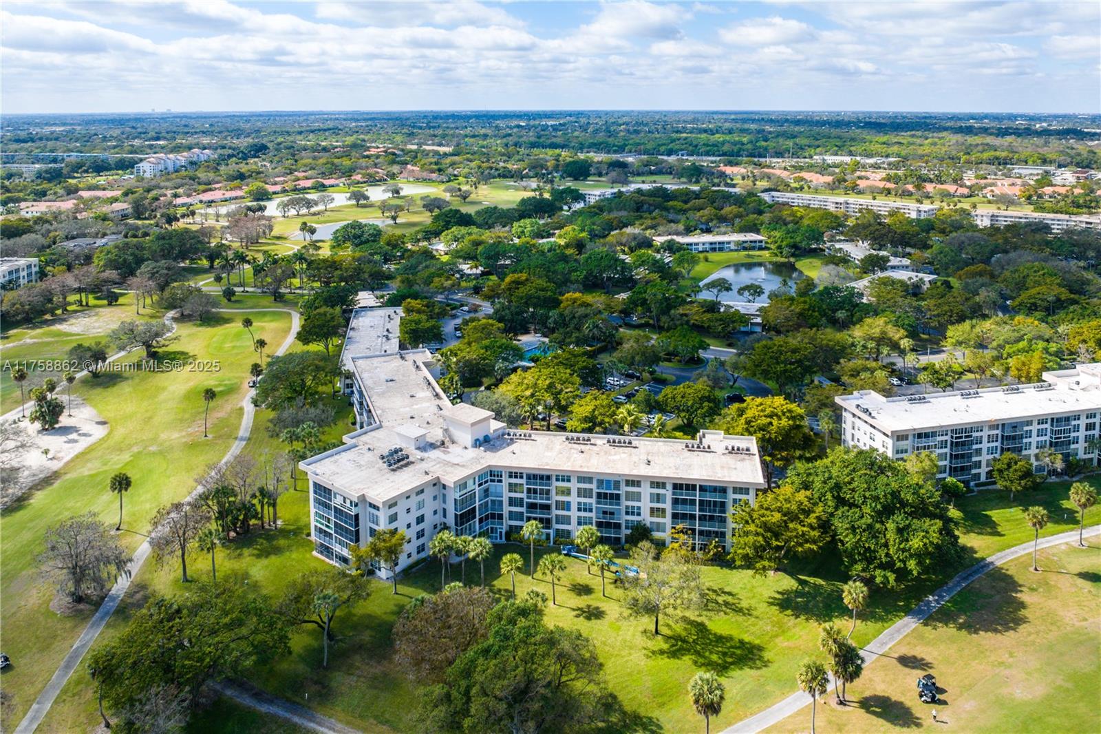3800 Oaks Clubhouse Drive, Unit 307 Pompano Beach, FL 33069 - Photo 25 of 25 an aerial view of residential houses with outdoor space and trees all around