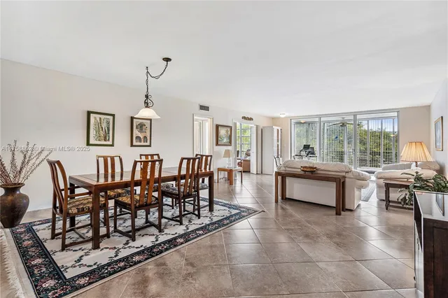 a living room with furniture a rug and a table