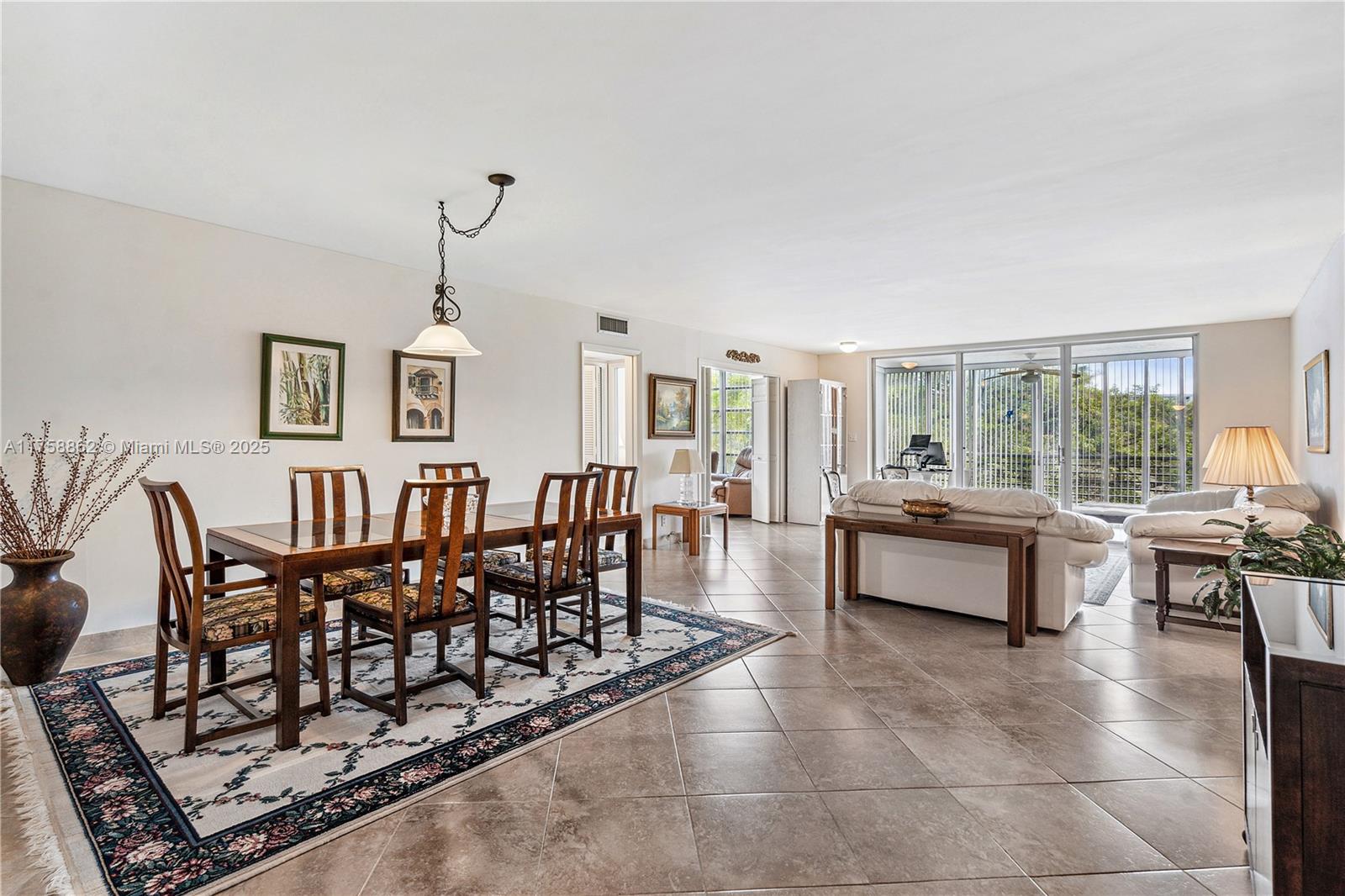 3800 Oaks Clubhouse Drive, Unit 307 Pompano Beach, FL 33069 - Photo 4 of 25 a living room with furniture and a floor to ceiling window