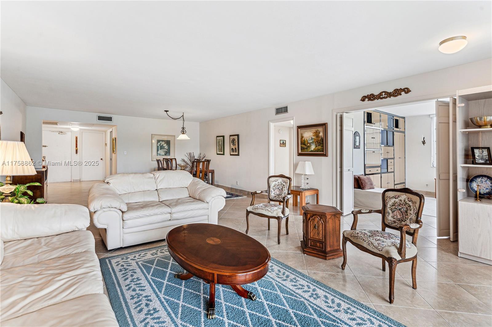 3800 Oaks Clubhouse Drive, Unit 307 Pompano Beach, FL 33069 - Photo 5 of 25 a living room with furniture a rug and a table