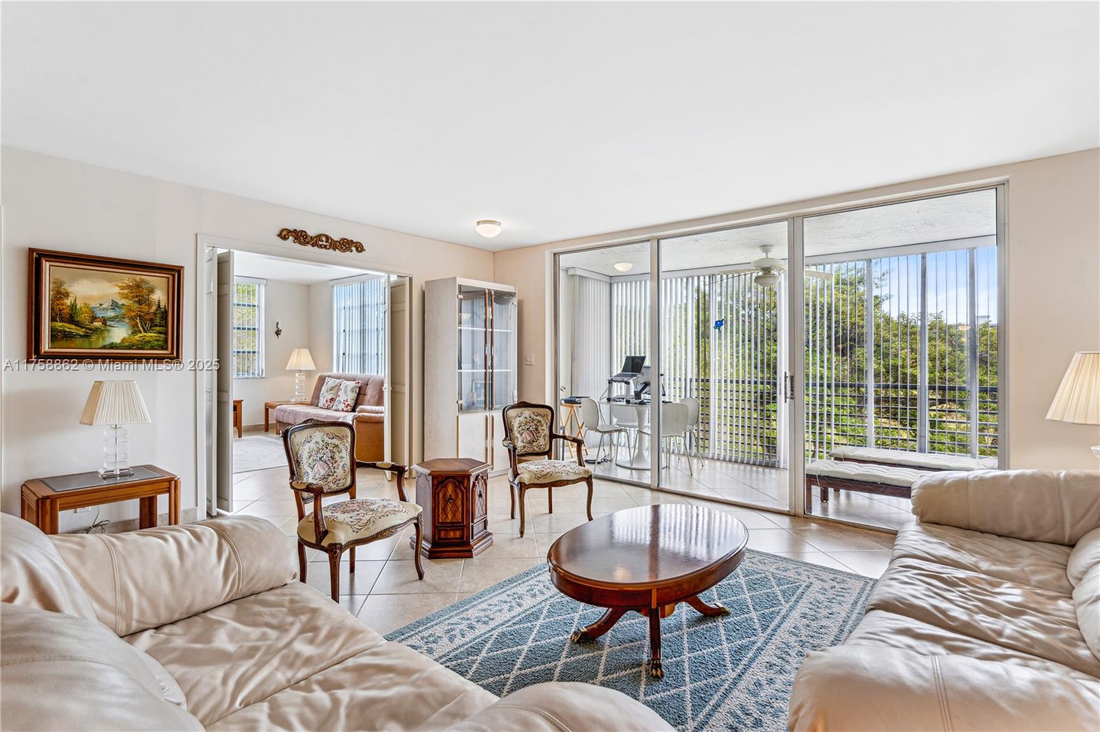 3800 Oaks Clubhouse Drive, Unit 307 Pompano Beach, FL 33069 - Photo 9 of 25 a living room with furniture and a large window
