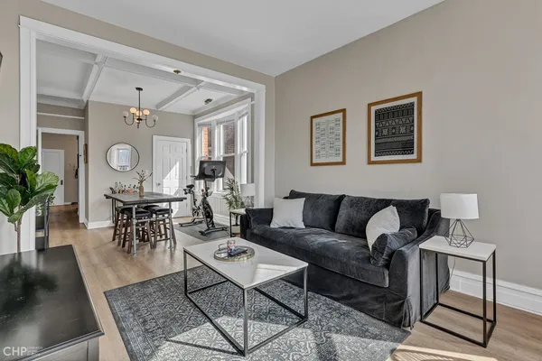 a living room with furniture a rug and a window