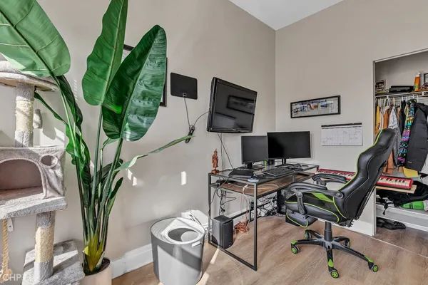 a view of a workspace with furniture and a potted plant