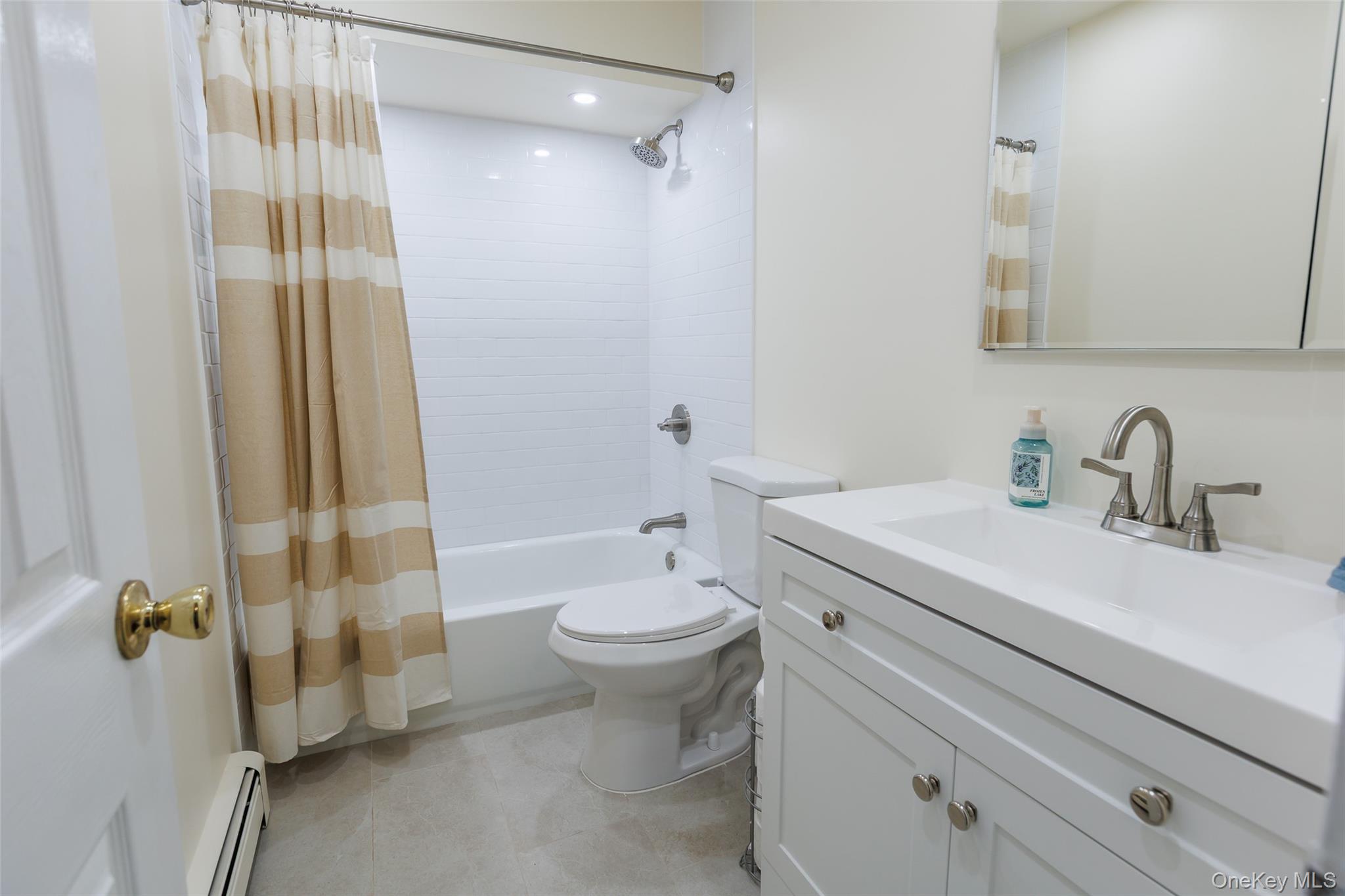 45 Terry Lane Commack, NY 11725 - Photo 16 of 34 a bathroom with a sink a toilet and shower