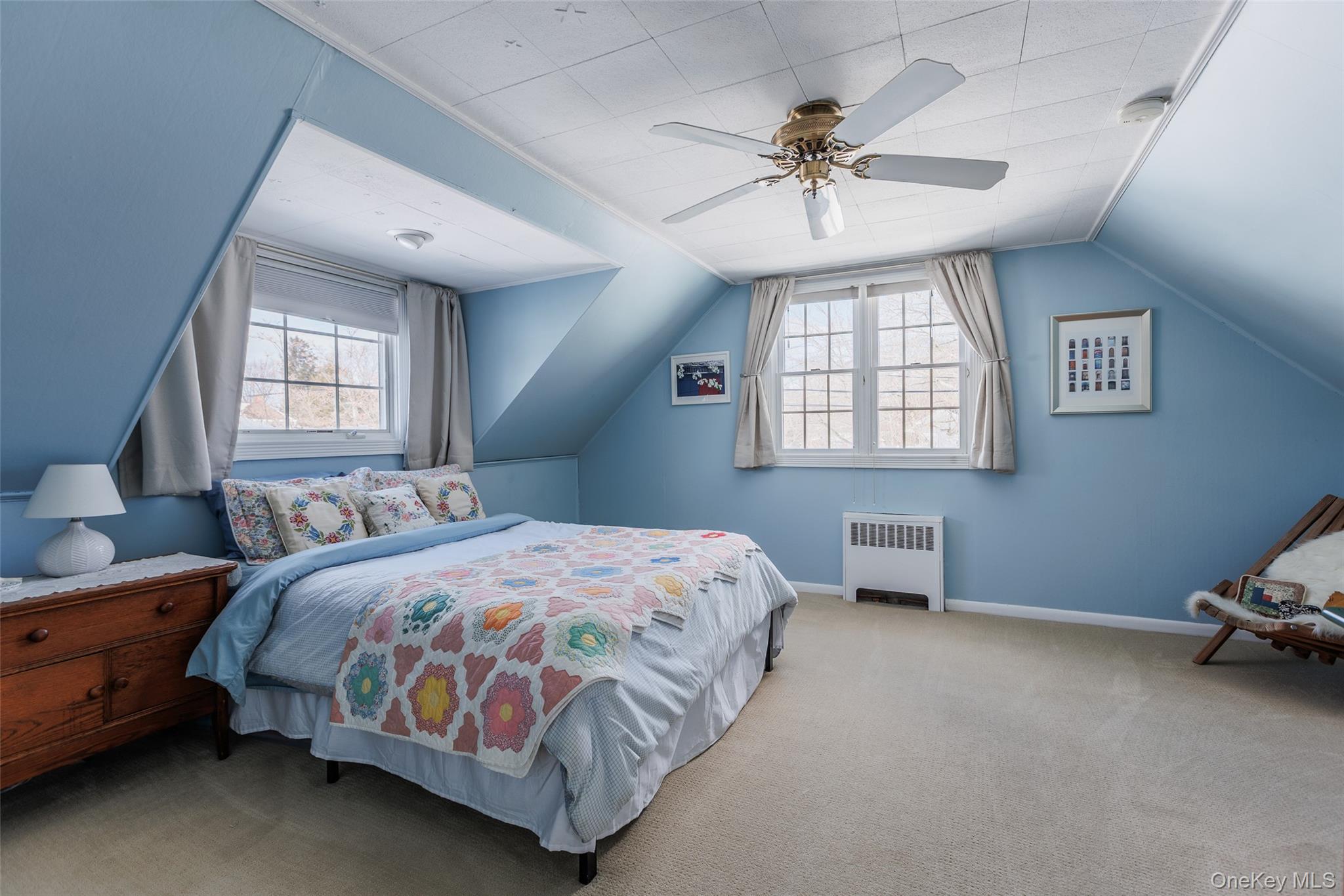 45 Terry Lane Commack, NY 11725 - Photo 20 of 34 a bedroom with a bed and a chandelier