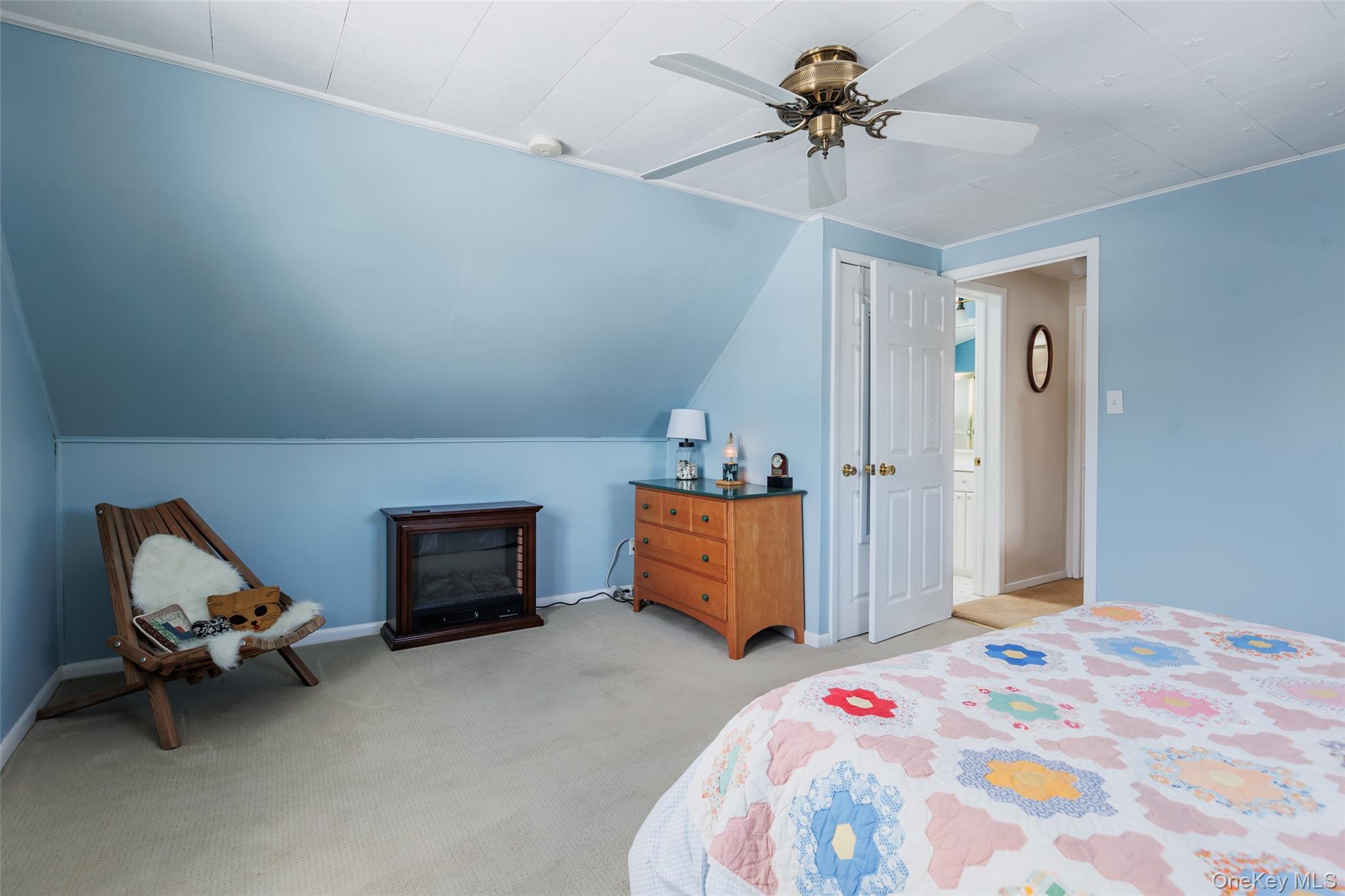 45 Terry Lane Commack, NY 11725 - Photo 21 of 34 a bedroom with a bed and a chandelier