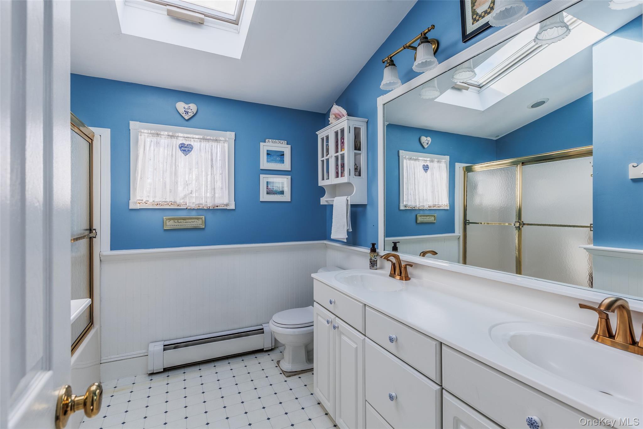 45 Terry Lane Commack, NY 11725 - Photo 22 of 34 a bathroom with a sink a toilet and shower