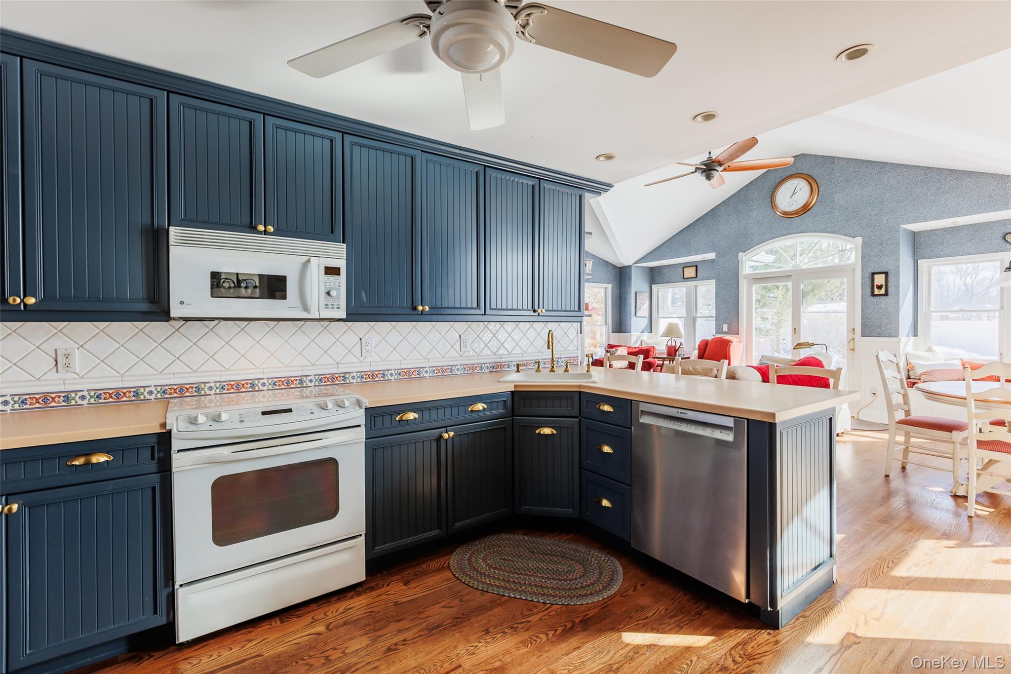 45 Terry Lane Commack, NY 11725 - Photo 8 of 34 a kitchen with wooden cabinets and white appliances