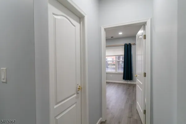a view of a hallway with wooden floor