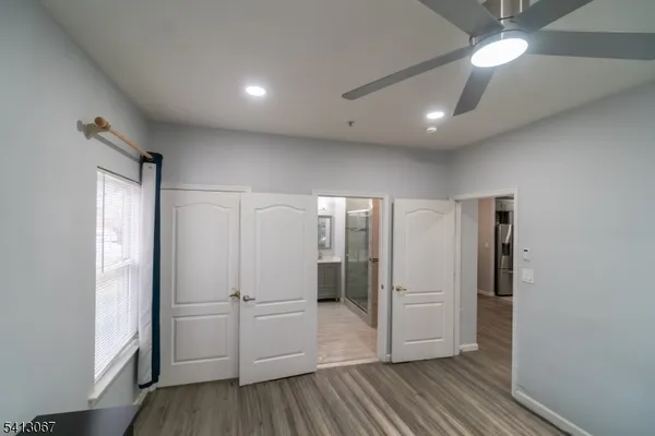 a view of empty room with wooden floor