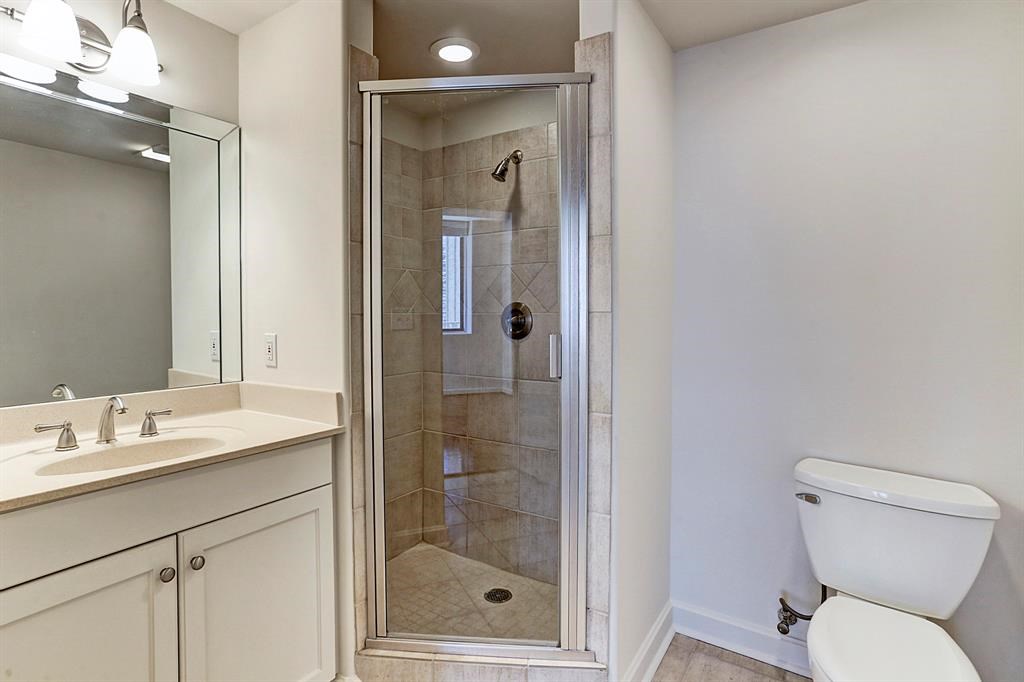 914 Main Street, Unit 1806 Houston, TX 77002 - Photo 9 of 21 a bathroom with a toilet sink vanity and shower