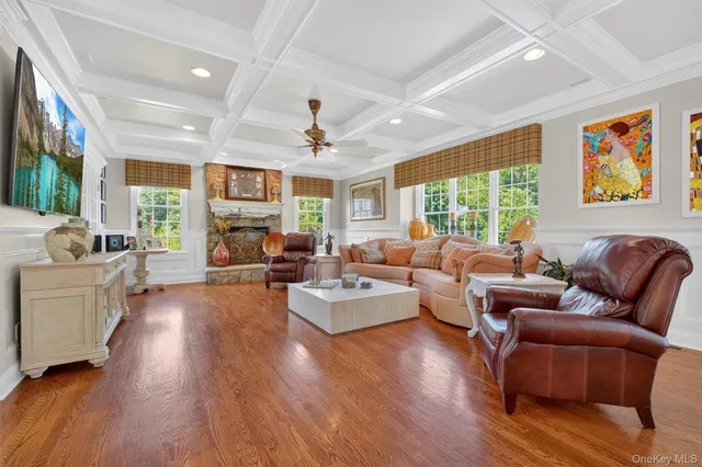 a living room with furniture fireplace and a large window