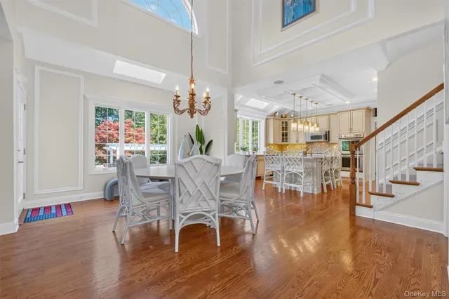 a living room with furniture wooden floor and a large window