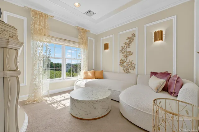 a spacious bedroom with a bed and a chandelier