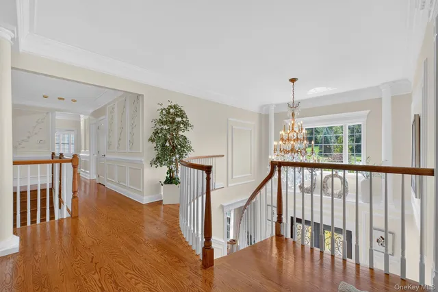 a living room with furniture a fireplace and a chandelier