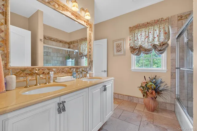 a spacious bedroom with a large bed and a chandelier