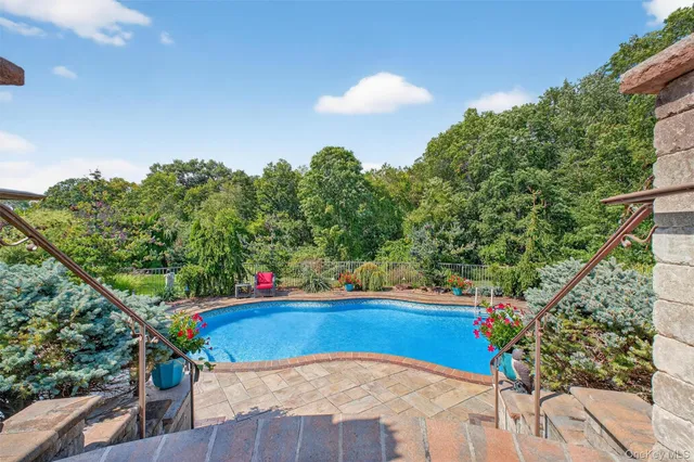 a view of a patio with a dining table and chairs with wooden floor and fence