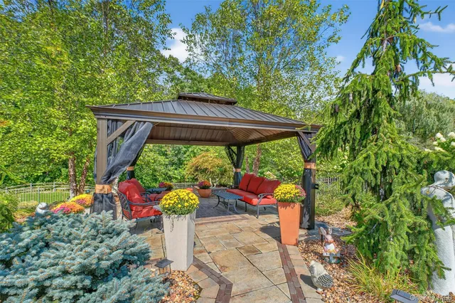 a backyard of a house with fire pit and outdoor seating