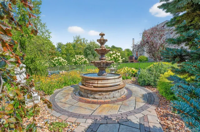 a backyard of a house with a yard and outdoor seating