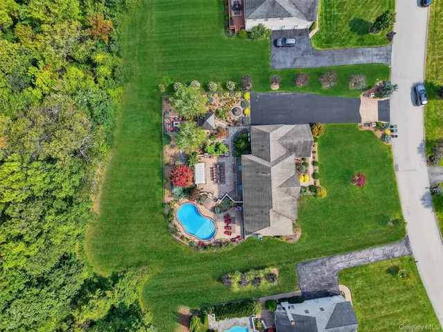 an aerial view of a house with a garden and swimming pool