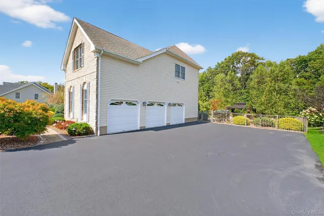 a front view of a house with a big yard and potted plants