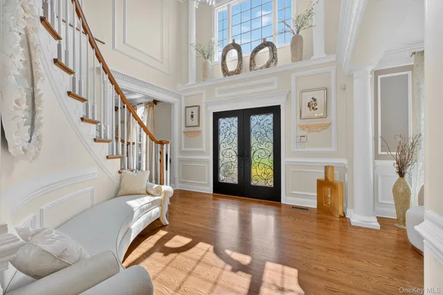 a front view of a multi story residential apartment building with yard and entryway