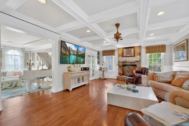 a living room with furniture and a book shelf