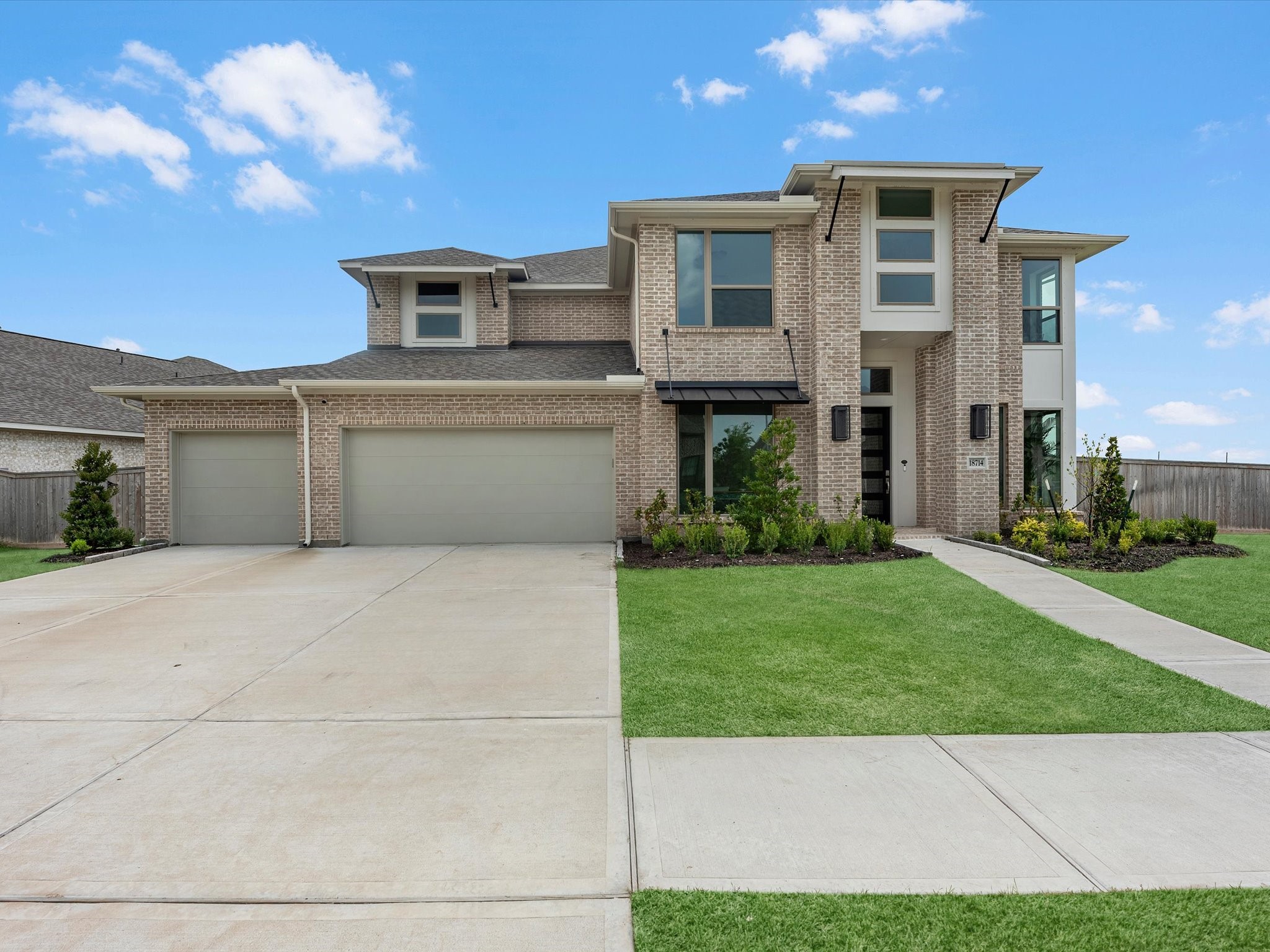18714 Pistachio Way Manvel, TX 77578 - Photo 2 of 48 Built by Perry Homes in 2025, this contemporary residence sits on an oversized 14,000+ square-foot corner lot and remains covered by the builder's 2-year systems and 10-year structural warranties.
