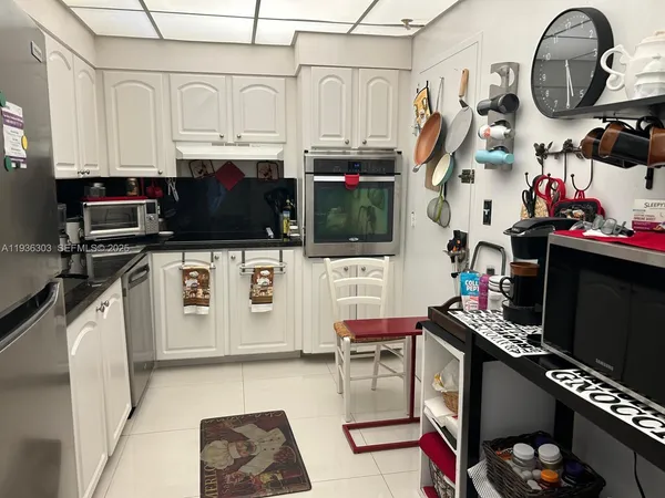 a view of kitchen with stainless steel appliances granite countertop a stove and a a refrigerator