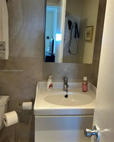 a bathroom with a sink and mirror