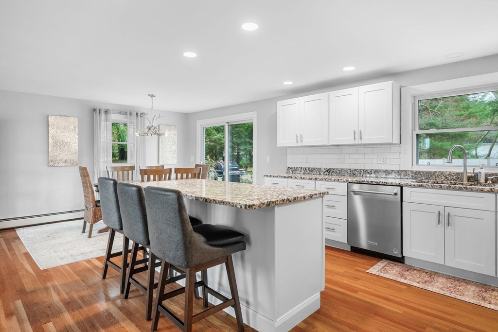 187 Echo Cove Road Hamilton, MA 01982 - Photo 11 of 42 a kitchen with granite countertop white cabinets and window