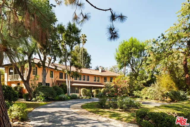 a front view of a house with a yard swimming pool and outdoor seating