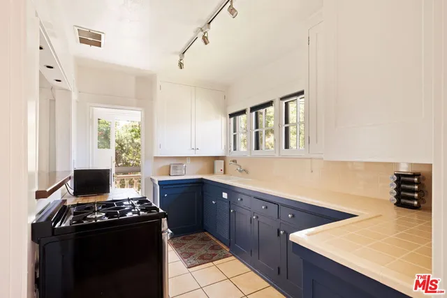 a kitchen with stainless steel appliances granite countertop a stove and a sink